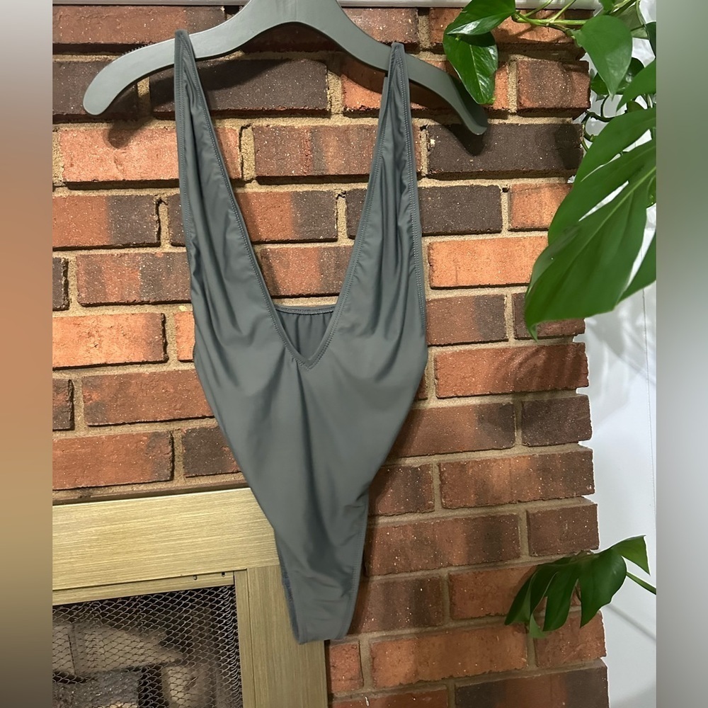 #4) Dippin’ Daisy’s. Olive green one piece swimsuit. Great condition.